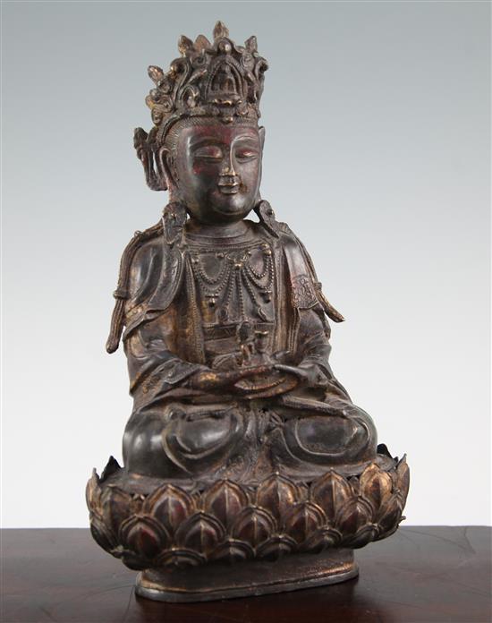 A Chinese late Ming bronze seated figure of a Bodhisattva, and stand, 16th / 17th century, 31.5cm.